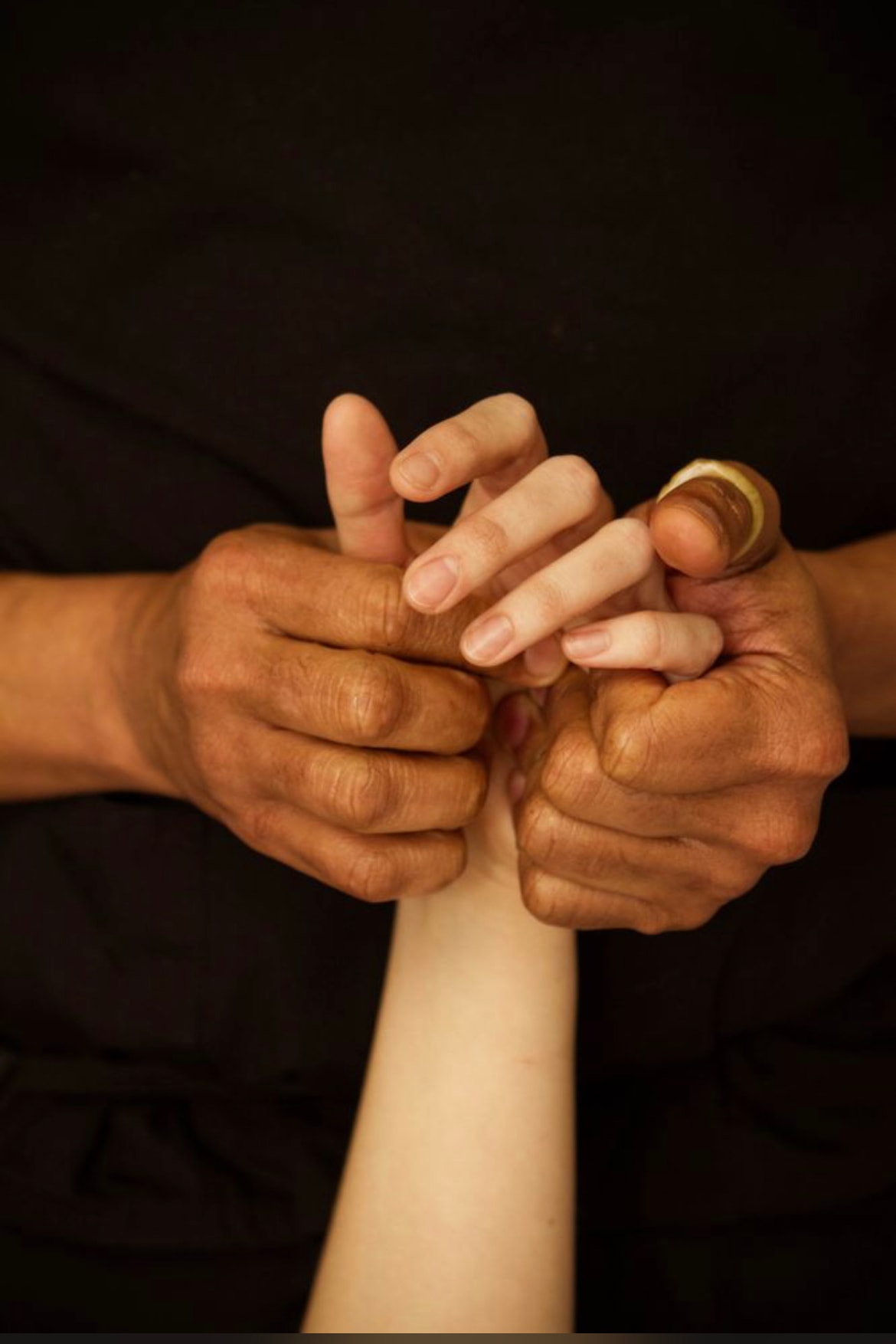 Hands held together in a moment of care and connection